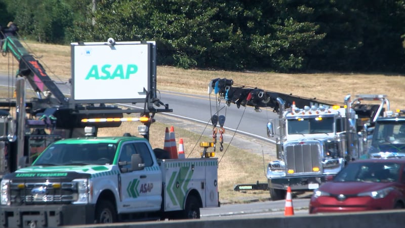 Recovery crews work at the scene of the tractor-trailer crash. The driver died 10 days later.