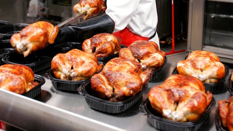 FILE - In this May 8, 2008, file photo, a butcher spreads out rotisserie-roasted chicken at...