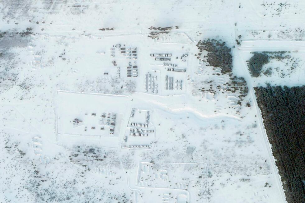 This satellite image provided by Planet Labs PBC shows vehicles and tanks stationed at the...