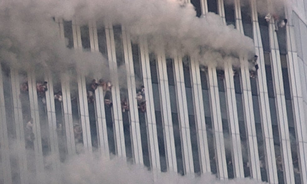 People hang out of broken windows of the North Tower of the World Trade Center in New York on...