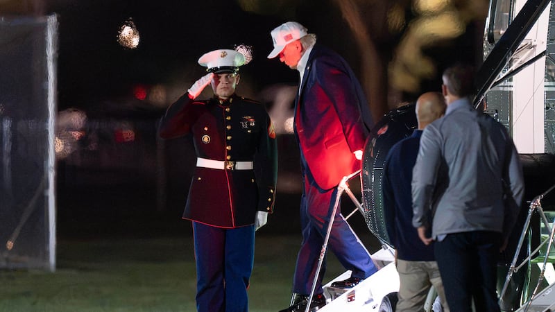 President Donald Trump steps off from Marine One upon his arrival at the Ellipse just outside...