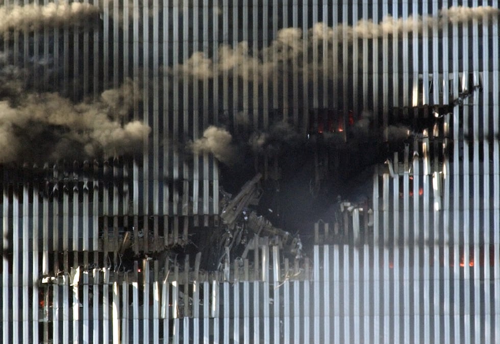 The north tower of New York's World Trade Center shows the impact left by a hijacked Boeing...