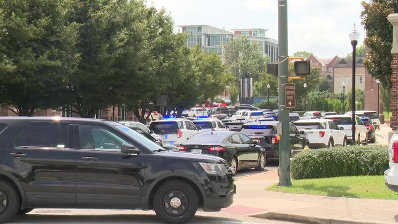 Officials give a press conference following UTC's lockdown on Thursday.