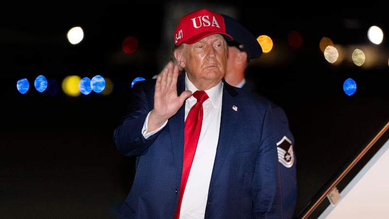 President Donald Trump waves as he arrives on Air Force One, Wednesday, Sept. 16, 2026, at...
