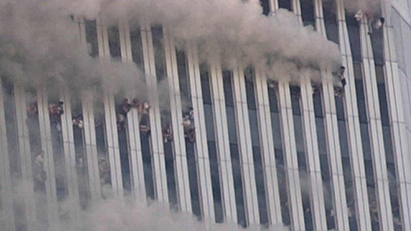 People hang out of broken windows of the North Tower of the World Trade Center in New York on...
