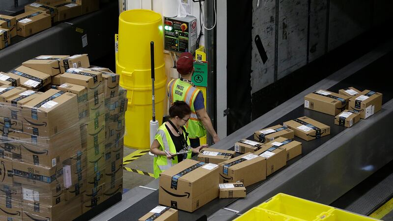FILE - Packages move down a conveyor system were they are directed to the proper shipping area...