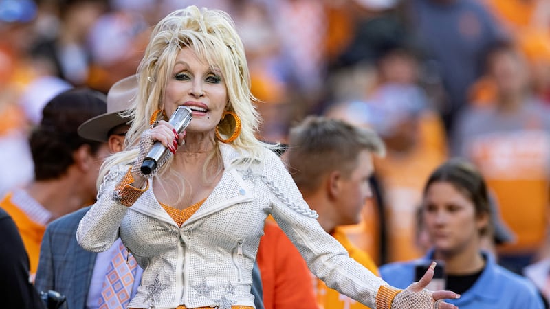 Dolly Parton performs during the first half of an NCAA college football game between Tennessee...