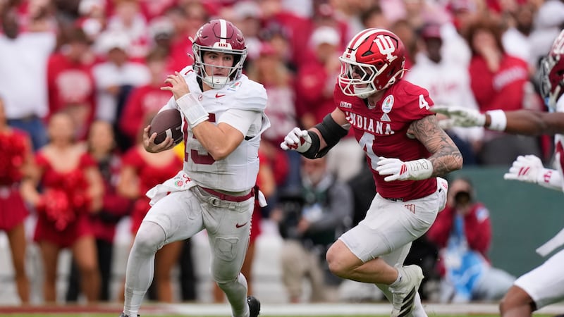 Alabama quarterback Ty Simpson (15) is chased by Alabama linebacker Qua Russaw (4) during the...