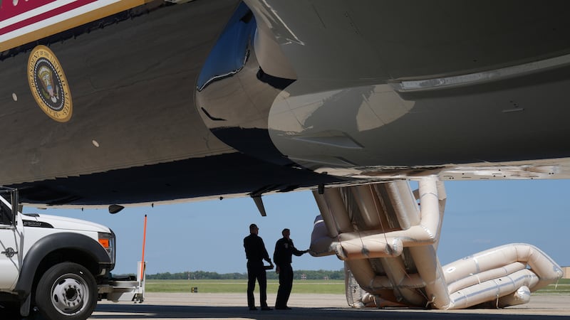 U.S. Air Force personnel talk after an emergency inflatable slide deployed on Air Force One...