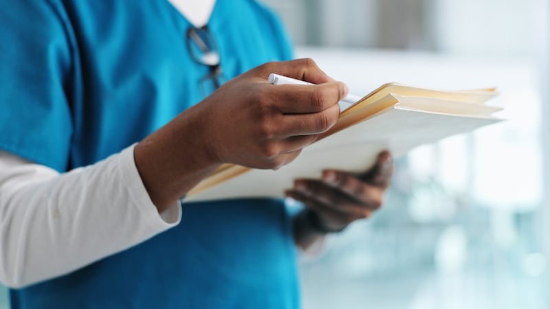 Healthcare, nurse and hands with documents, writing and professional with records of diagnosis...
