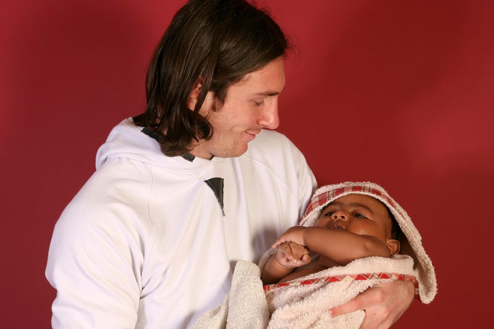 20-year-old soccer star Lionel Messi cradles Lamine Yamal, who was merely six months old at...
