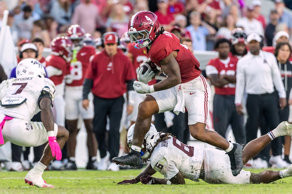 Alabama running back Daniel Hill (4) runs the ball over Texas A&M cornerback Julio Humphrey...
