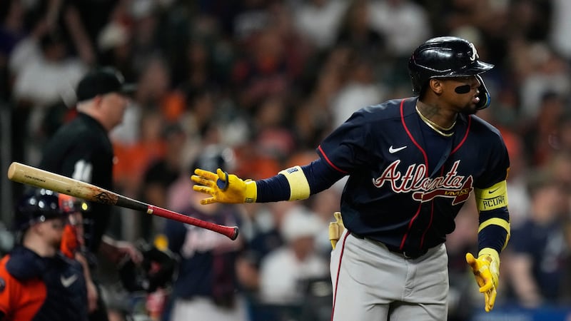 Atlanta Braves' Ronald Acuña Jr. tosses his bat after hitting a home run during the seventh...