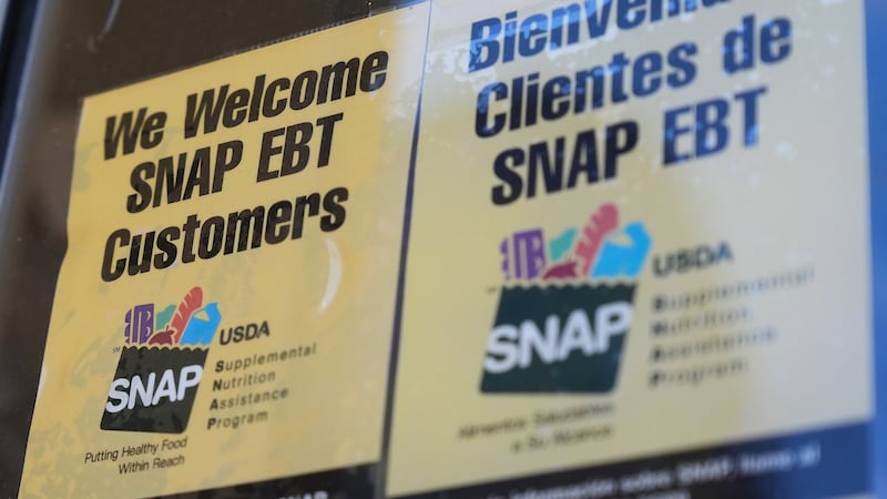 A SNAP EBT information sign is displayed outside of a convenience store in Baltimore, Monday,...